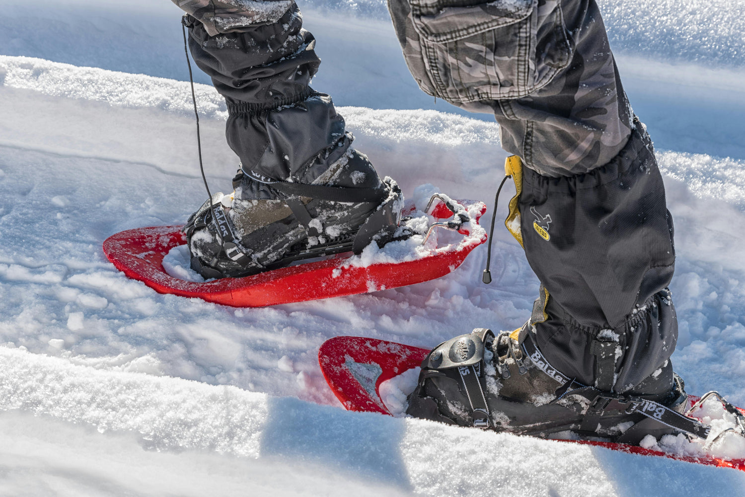 Person snowshoeing on a snowy landscape